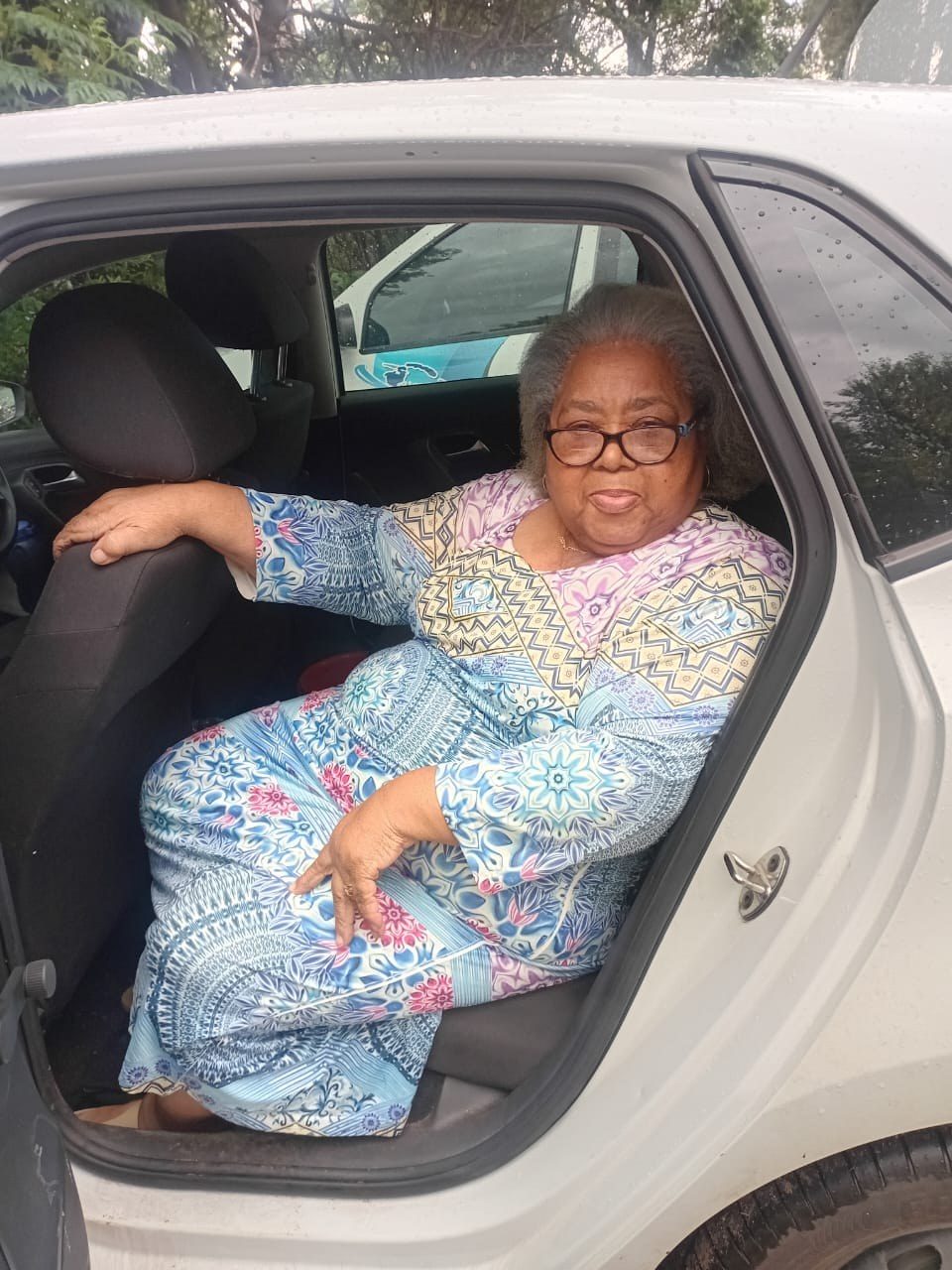 Lindiwe Millicent Mokuena seated in a car and smiling.