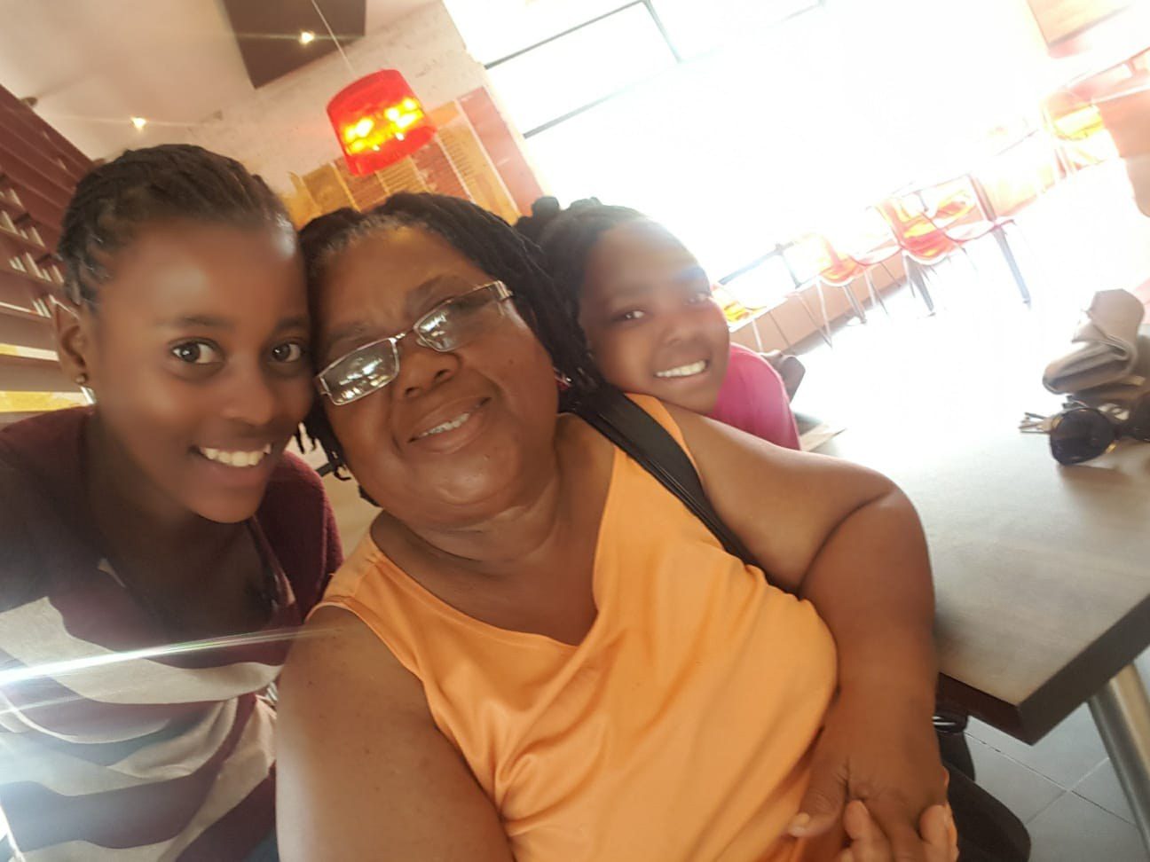 Lindiwe Millicent Mokuena smiling with family.
