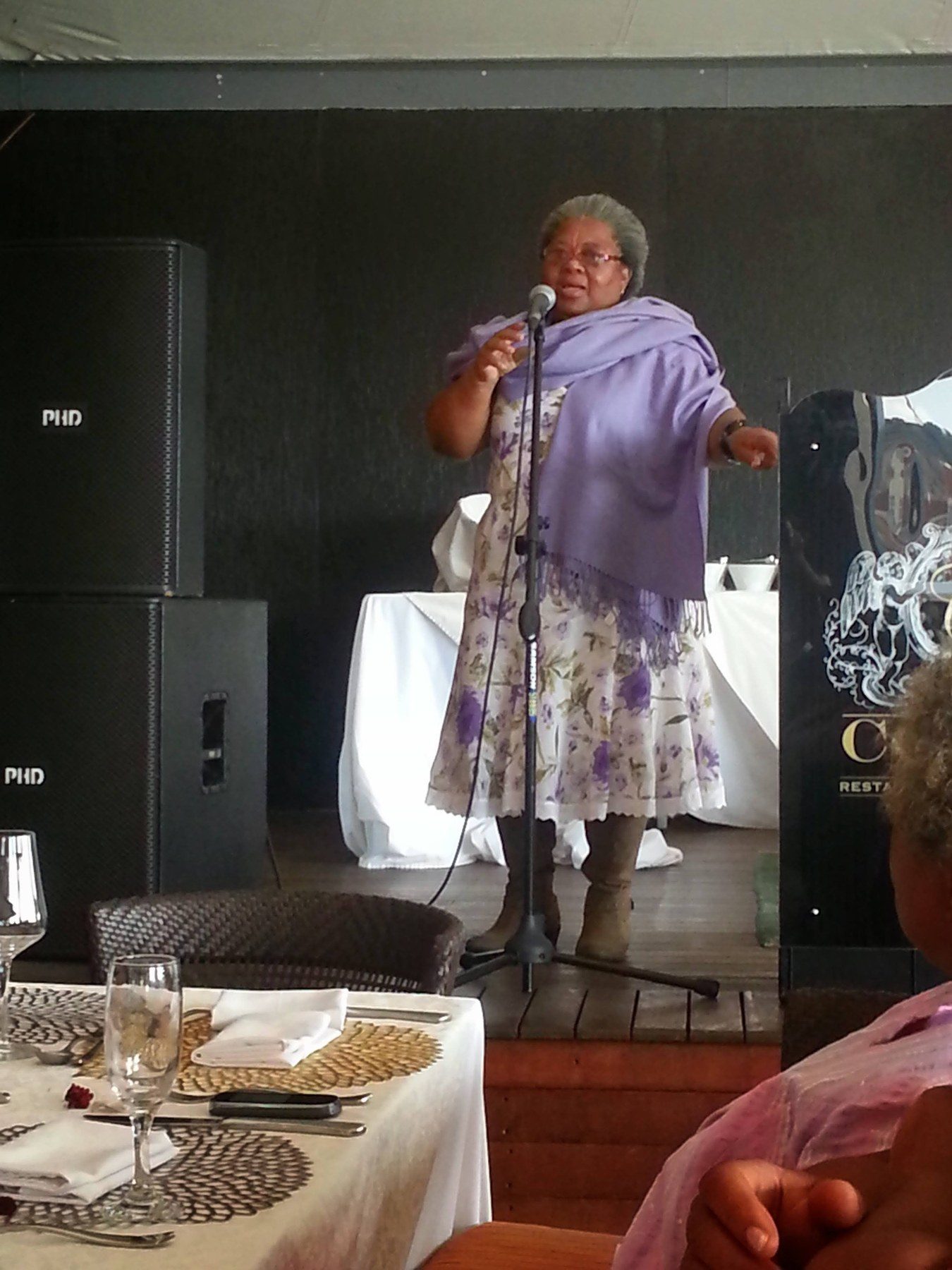 Lindiwe Millicent Mokuena speaking into a microphone.